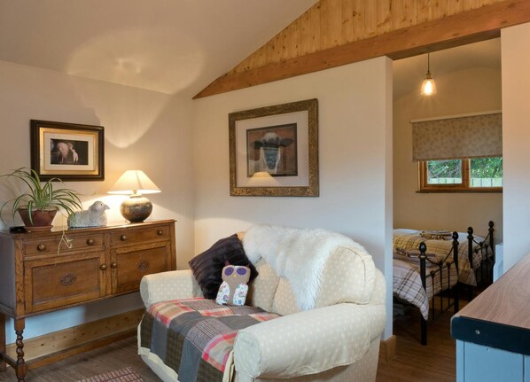 Living and kitchen area and view into bedroom area