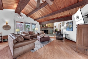 Large living room with vaulted cedar ceiling and lake views