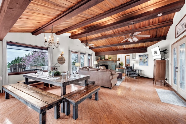 Large living room with vaulted cedar ceiling and lake views