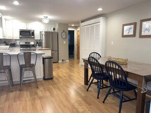 Spacious kitchen with table for 9 and 2 counter stools