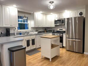 Well-stocked kitchen with brand new stainless steel appliances