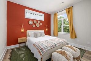 Cozy bedroom with well-thought interior and plush beddings