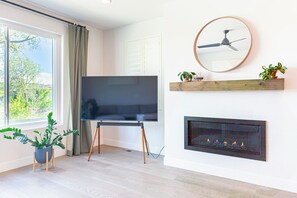 Indoor fireplace and 65 inch smart TV.
