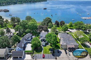 Aerial view of home and proximity to the lake! Right across the street. Red car is parking area