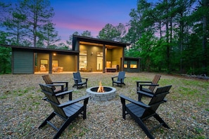 Where laughter echoes and flames dance: our cabin's fire pit.