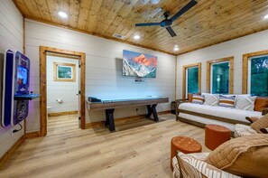 Enjoy endless entertainment in our living room, designed for both cozy lounging and thrilling game nights.