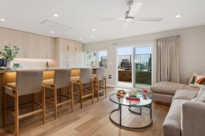 Gorgeous, newly remodeled living room, facing kitchen and breakfast bar.