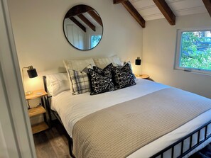 Downstairs King Bedroom with soft, comfortable bedding and blackout shades.