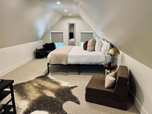 Large cozy bedroom with a/c unit, 2 fold out futons and smart tv.