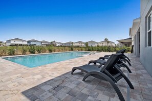 Ample lounging space ensures everyone has a sunny spot to relax after a swim.
