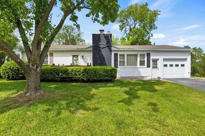 Discover the charm of this cozy lakeside home, nestled among mature trees and offering a tranquil escape with a classic touch.