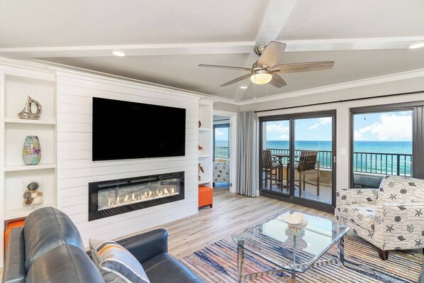 Really breathtaking gulf view from the den with a 65" smart television and fireplace. 
