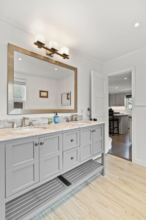 Well-lit vanity with ample storage for grooming needs