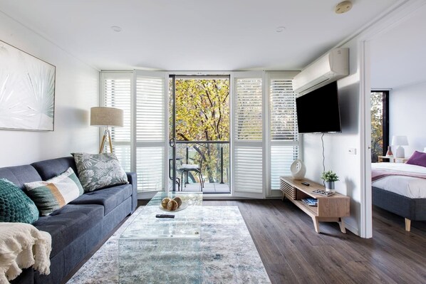 The living room opens to the balcony, creating a lovely transition between the indoors and out.
