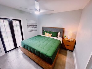 Bedroom 1
Equipped with a comfortable King Bed. This room is small but comfortable, with a dresser and closet  to keep belongings tidy, a smart TV to keep you entertained and a ceiling fan to keep you extra cool. Direct access to the backyard.