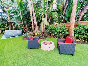 The Backyard

A large backyard full of Lucious greenery all around. The backyard has an outdoor table for all guests, 6 lounge chairs to soak in the sun, a fire place, and an above the ground pool to stay cool year around.
