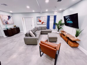 Our Living Room

Equipped with plenty of sunlight a large sectional and even bigger TV to keep you entertained through your stay. The living room is spacious for all sorts of groups.