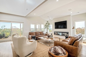 Upscale coastal livingroom with tons of natural light