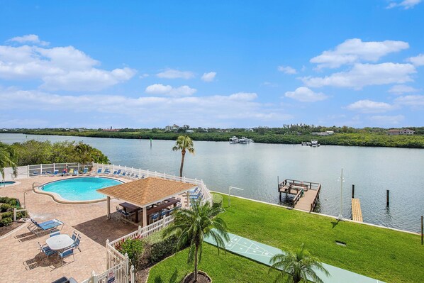 Balcony view of pool, fishing/boat docks, and peaceful Intracoastal Waters.