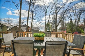 Relax on our spacious deck overlooking serene lake and forest views.