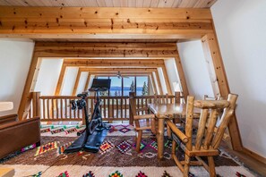 A dynamic loft space can be used for reading, playing cards at the table, or exercising on the stationary bike, all while enjoying the lake views.