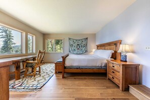 The master bedroom is a private oasis, the only room downstairs it includes an en suite bathroom, a workspace, and lake views.