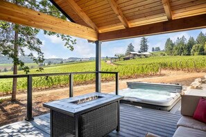 Large covered deck with recessed 6 person hot tub.