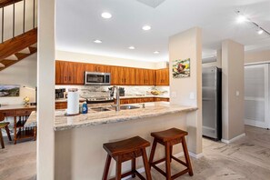 The breakfast bar with seating for two, perfect for quick meals and chats.