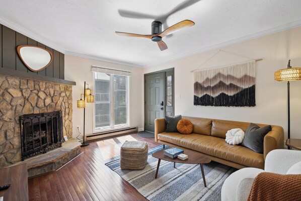 Enter the condo to a welcoming living area with gas fireplace and comfy seating