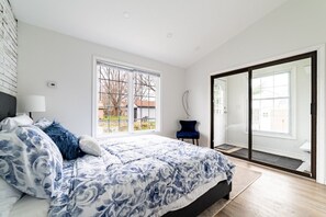 Master bedroom with a Queen size bed. Equipped with a medium firm memory foam mattress, fresh cotton linens, and 4 pillows.