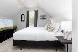 Retreat to the spacious upstairs suite, complete with a comfy king bed, smart TV, and plenty of room to relax.