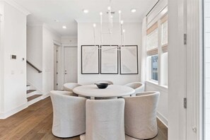 A beautifully designed dining space with a modern round table, comfortable chairs, and statement lighting for memorable gatherings.