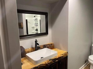 Live edge slab counter top and back splash adds to the lodge look of "The Oaks"