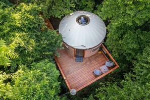 A cozy yurt nestled in the woods.