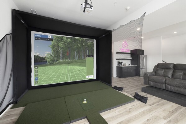 PGA Clubhouse - Basement Level: Family & Game Room w/ golf simulator, putting green, and pop-a-shot