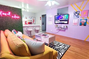 Bring your social media to life with the many photo ops in this room. Then relax on a nice vibrant sofa in this dream living room, and take full advantage of your Roku TV complete with several streaming services.
