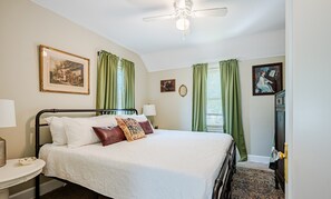 Relax on the king-sized bed in this charming bedroom. 