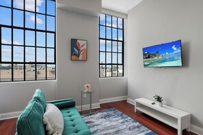 Smartly designed common space with a comfy couch, smart TV, and nice natural light.  All you have to do is log into your favorite streaming services and make it a TV night.
