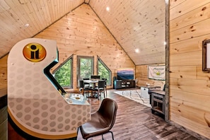 The upstairs living room/game room is the perfect place to relax and unwind at the cabin.