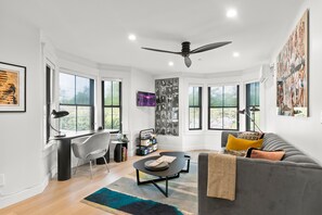 Relax in the stylish living room featuring a cozy queen sleeper sofa