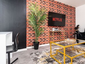 Living room  - 50'  Smart TV loaded with Netflix, HDMI cable, ambient lighting,  extra fast Wi-Fi & a Foosball table - Complimentary tea & coffee available for your enjoyment