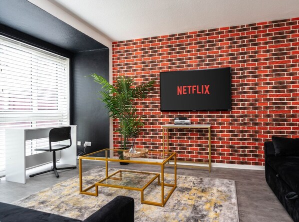 Living room  - 50'  Smart TV loaded with Netflix, HDMI cable, ambient lighting,  extra fast Wi-Fi & a Foosball table - Complimentary tea & coffee available for your enjoyment