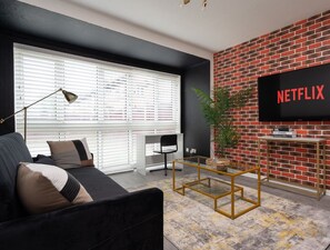 Living room  - 50'  Smart TV loaded with Netflix, HDMI cable, ambient lighting,  extra fast Wi-Fi & a Foosball table - Complimentary tea & coffee available for your enjoyment