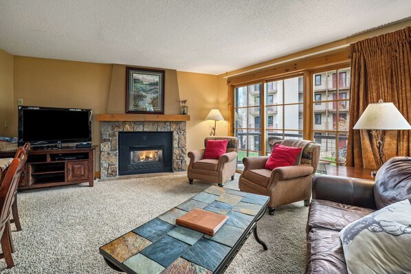Couch, fireplace, sliding glass door. 