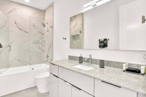 Relax in style with a spacious shower and sleek finishes.