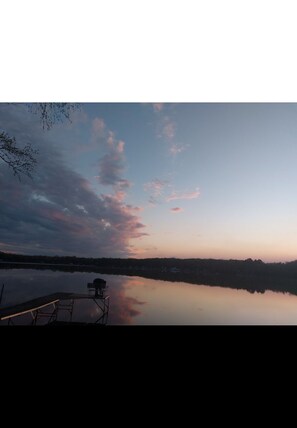 Enjoy the sunsetting over the horizon relaxing on the dock bench.