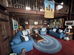 living room with loft above