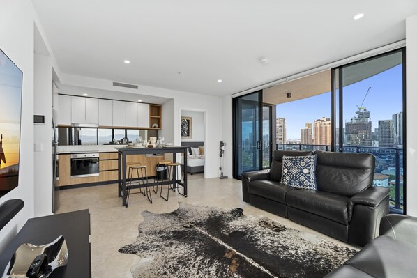 Fully equipped modern kitchen is right next to the living area