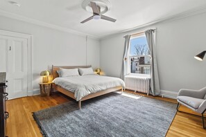 Rest comfortably in the serene master bedroom, offering a cozy king-sized bed, soft lighting, and a peaceful atmosphere