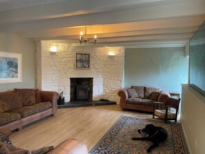 Living room with wood burner and 85" Smart TV
